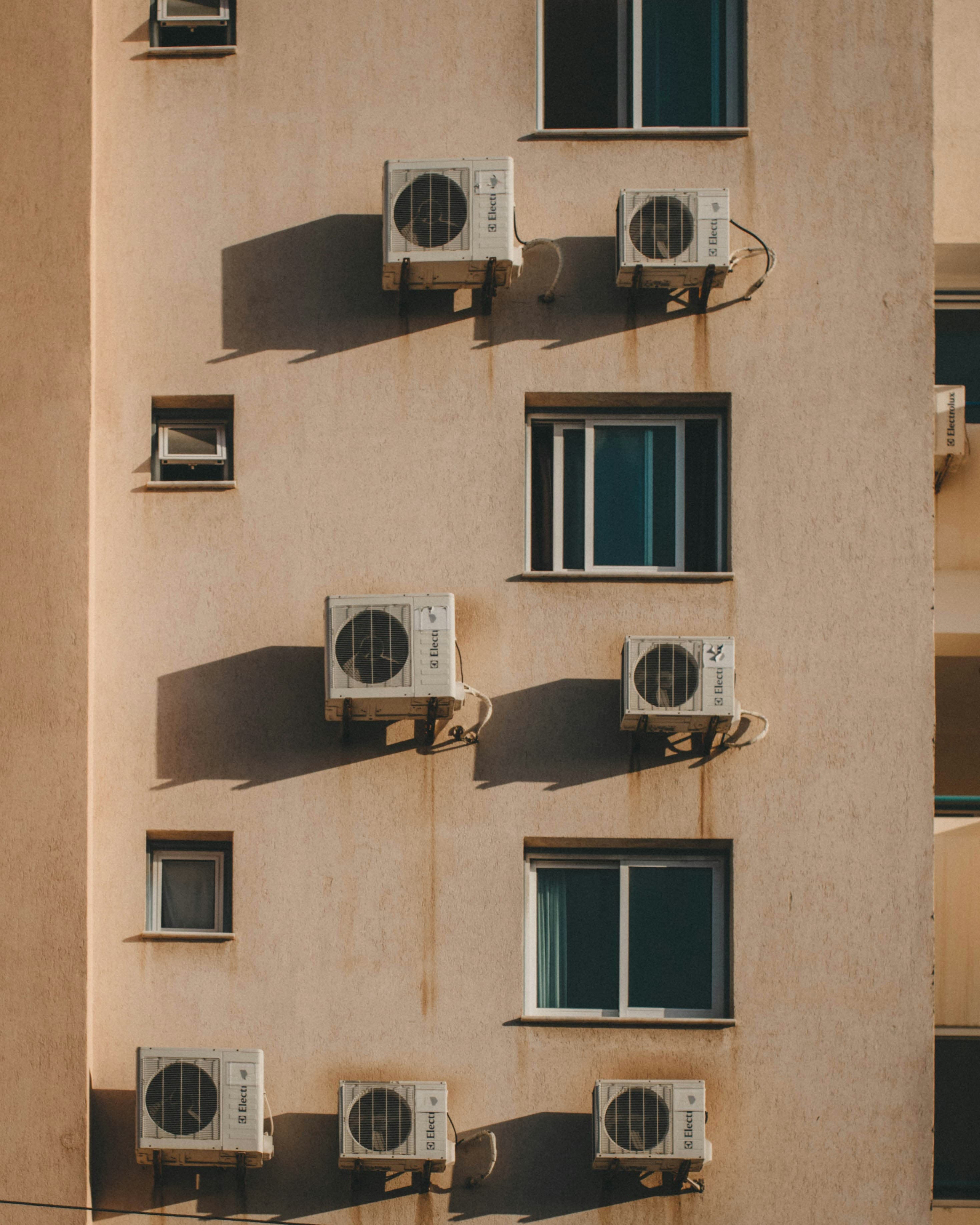 Outdoor air conditioning condenser units mounted on an exterior wall