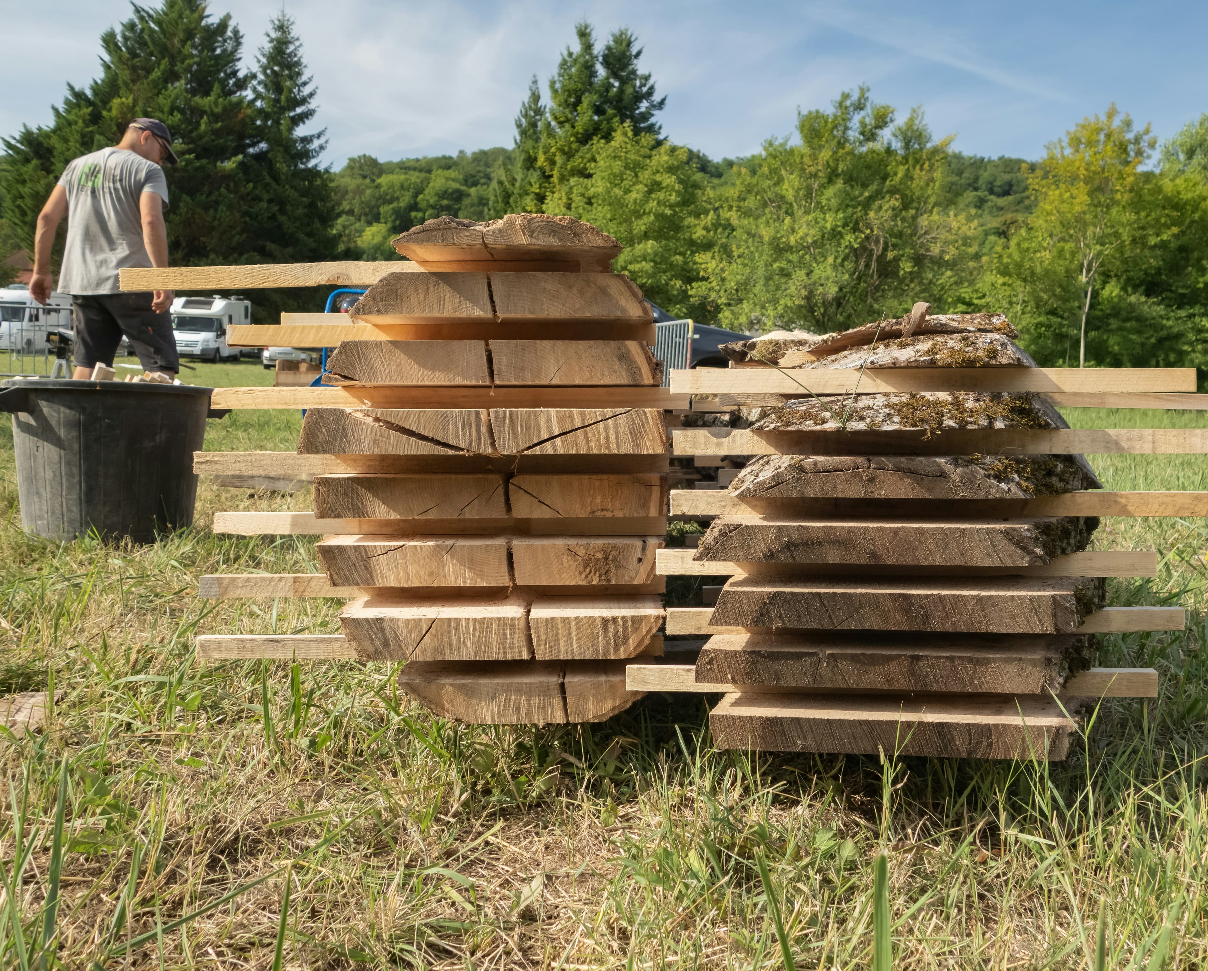 A contractor assembling wooden planks on an outdoor building project